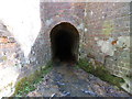 Closeup of culvert under railway embankment