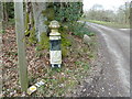 Coat of arms on post by footpath 119