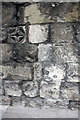 Benchmark and decorative stone on Exeter Street wall