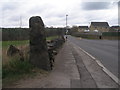 Benchmark on a gatepost opposite Kirkwood Close