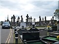 A forest of Celtic crosses beyond the entrance to Milltown Cemetery