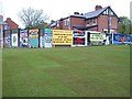 Billboards on the perimeter wall of the site of the former Andersonstown RUC barracks