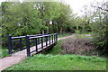 Footbridge over a stream at the edge of Old Farm Park