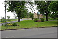 Road to Hanslope and the village sign