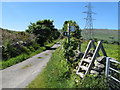 Road, stile and pylon