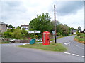 SO0130 : Signpost and phone box on a grass triangle, Cradoc by Jaggery