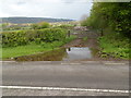 Large puddle in front of a field gate south of  Cwrt-y-defaid