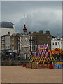 Margate: beach amusements and clock tower