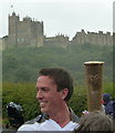 Olympic torch bearer below Bolsover castle