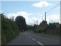 Bend in the road and traffic island in Charfield