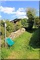 Path climbs away from lane in Chedworth