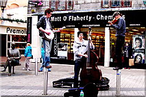 M2925 : Galway - William Street - Three Musicians (Two Standing on Posts)  by Suzanne Mischyshyn