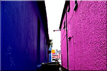 R3377 : Ennis - Parnell Street - Narrow Passageway between Blue & Pink Buildings by Suzanne Mischyshyn