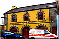 R0579 : Milltown Malbay - Main Street (N67) - Tom Malone's Pub & Market House by Suzanne Mischyshyn