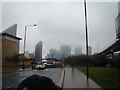 View of Canary Wharf disappearing into the clouds from Blackwall Way