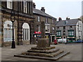 SK0573 : Market cross by the town hall and shops, Buxton by Andrew Hill