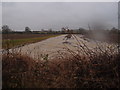 TL1183 : Flood water flowing down an arable field by Michael Trolove