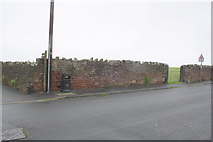 NY0337 : Wall of the Roman Fort at Camp Road/footpath junction by Roger Templeman