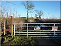 Barbed wired gate with signs