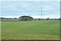 NO3737 : Pylons across the farmland near Wynton by Steven Brown