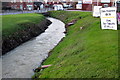 The River Tiffey flows by the industrial estate