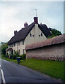 Thatched cottage and a thatched wall, West Amesbury, Wiltshire