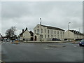 Looking across a mini-roundabout towards a former Congregational chapel