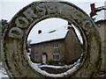 Corscombe: a thatched cottage through a circle