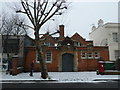 Pedestrian passing the former Postmen