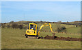 Digger in field near Holborn