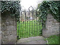 View through a gate at the rear of the church in Redwick