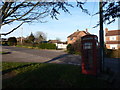 Motcombe: red phone box at Elm Close