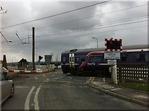 NT1067 : Train crossing Station Road at Kirknewton by Darrin Antrobus