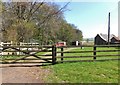 Track and agricultural buildings near Percy