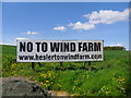 Opposing the turbines.