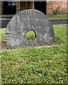 Millstone used as a headstone, All Saints