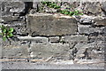 Benchmark on wall on north side of Dundas Street