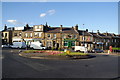 Row of shops and roundabout at Oakes