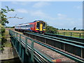TL4593 : Train crossing The Sixteen Foot Drain at Stonea by Richard Humphrey