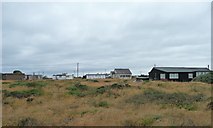 TR0917 : Dungeness cottages by Christine Johnstone