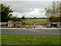 Boulders and a metal post at a field gate, Seawall Road, Goldcliff