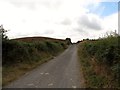 Glenloughan Road approaching the cutting through a drumlin