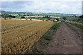 SO5228 : Harvested wheatfield and Elvaston Farm by Philip Halling