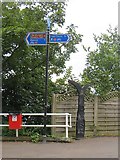 D4003 : Milepost and signpost, Larne by Richard Webb