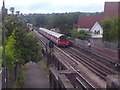 TQ2487 : Train approaching the bridge on Woodstock Road (2) by David Howard