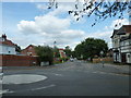 Looking across a mini-roundabout in Oxford Road towards School Road