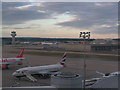 Air Traffic Control tower and planes at Gatwick airport, seen from the north terminal