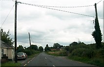N0819 : Power lines crossing the R357 (Hill Street) on the eastern outskirts of Cloghan by Eric Jones