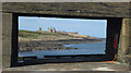 NU2519 : Dunstanburgh Castle, seen from the South Pier, Craster Harbour by Graham Robson