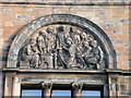 Tympanum relief group on former Anderson